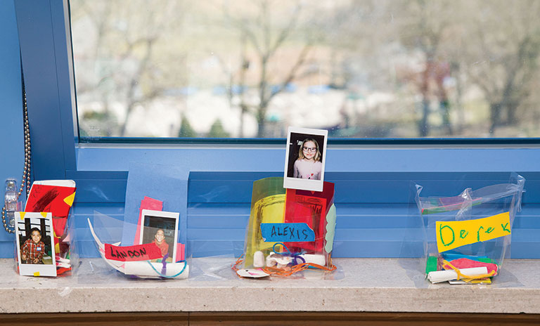 Student artwork on teh window sill of a school room.