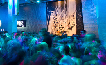 A colorful photo of teens at the Wahol Museum' LGBTQ Youth Prom
