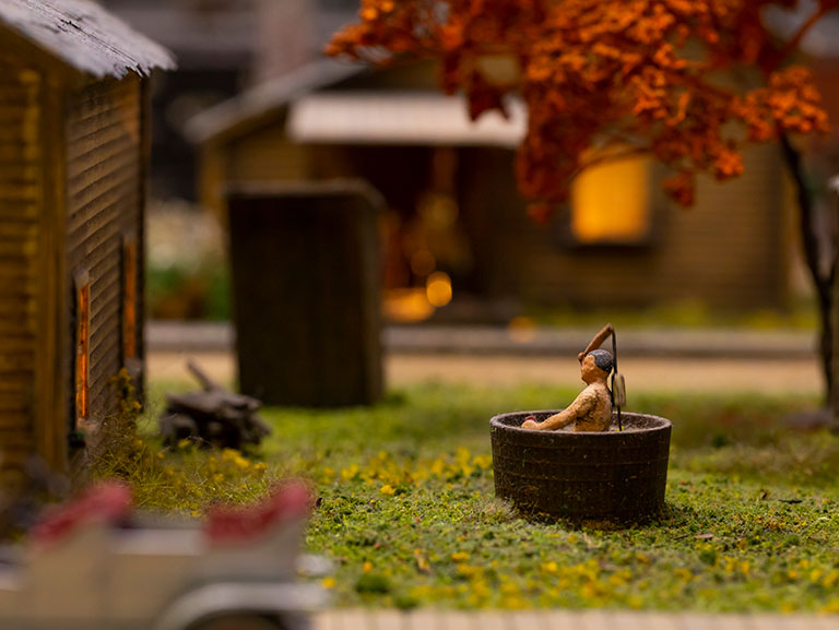 miniature figure of a man in an old time bathtub.