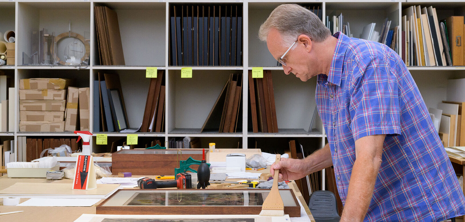 Portrait of Dale Luce at work in the Carnegie Museum of Art's framing room.