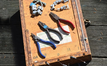 A hand-made banding box with bands and tools set out on top of it.