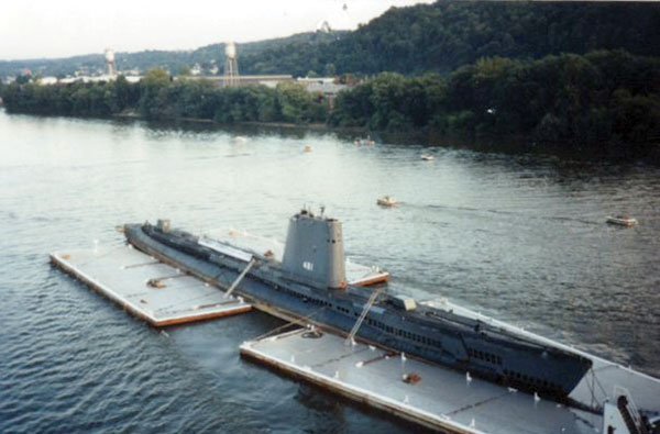 A submarine being towed in a river