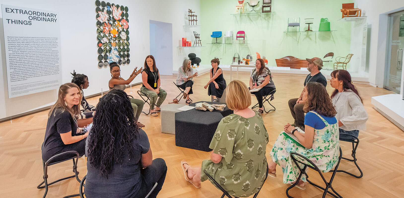 A group of teachers sitting in a circle, talking and laughing.