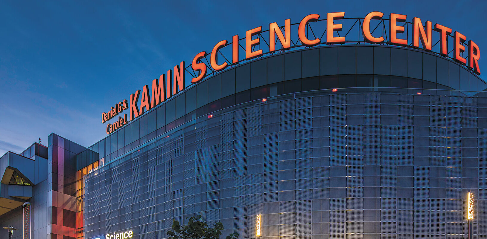 An exterior view of the science center building with the new Kamin Science Center letters around the top of the building.