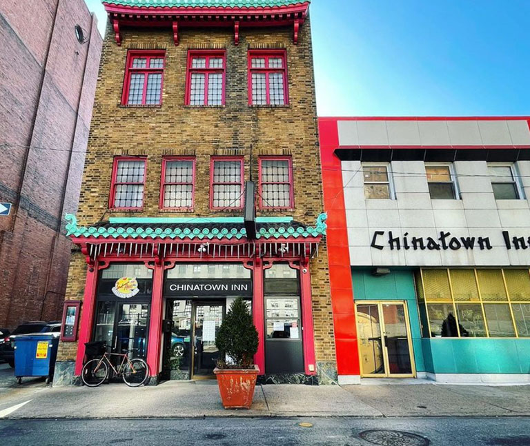 A photo of a building with the words Chinatown Inn across the front.