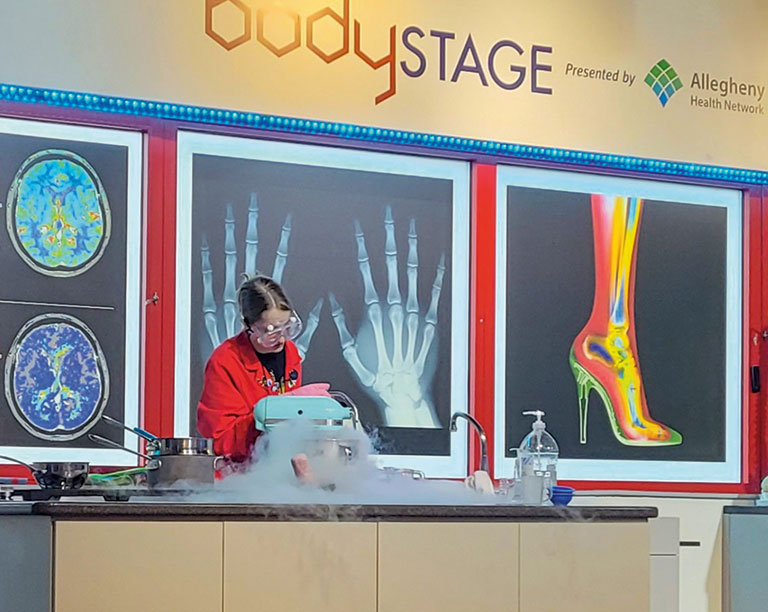 A young female volunteer conducting an experiment at the science center.