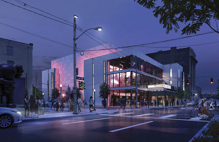 A modern building with colorful lighting at twilight, bustling with pedestrians, cars, and bicycles in an urban environment.