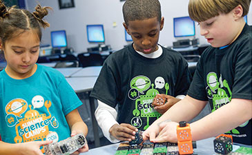 Young people participating in a science experiment.