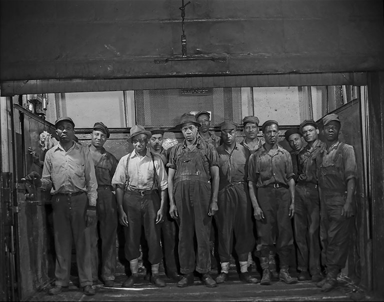 Grease makers and kettle tenders ascending by a freight lift to their work stations