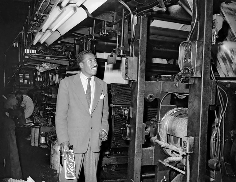 A photo of Gordon Parks in a factory.
