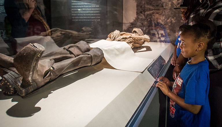 A mummified body wearing leather boots.
