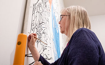 Conservator working on a piece of Warhol's artwork