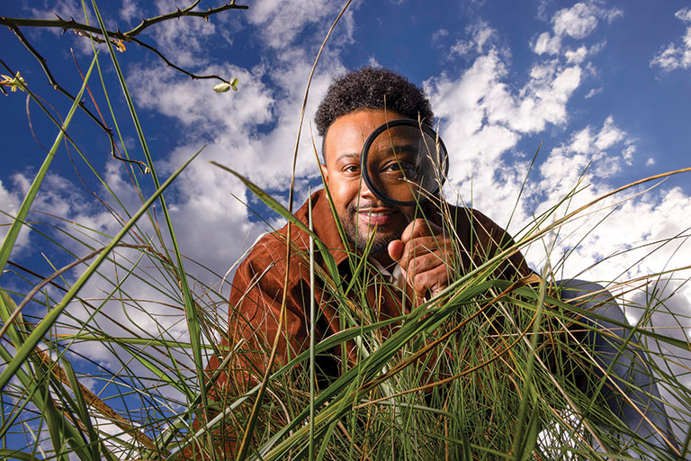 A naturalist looking through a magnifying glass